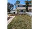 Charming two-story home featuring a well-manicured lawn, decorative landscaping and a white picket fence at 2714 Hunt Club Ln, Orlando, FL 32826