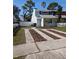 Two-story home with a unique driveway design, complemented by fresh landscaping and a tidy front lawn at 2714 Hunt Club Ln, Orlando, FL 32826