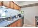 This is a nice kitchen with a stainless steel sink and a black dishwasher at 2714 Hunt Club Ln, Orlando, FL 32826