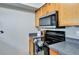 The kitchen features a black electric range and a stainless steel microwave at 2714 Hunt Club Ln, Orlando, FL 32826