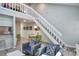 Bright living room featuring neutral decor, white stairs and a dining area at 2714 Hunt Club Ln, Orlando, FL 32826