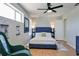 Calm bedroom with ceiling fan, a large window and minimal furniture at 2714 Hunt Club Ln, Orlando, FL 32826