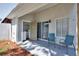Covered outdoor patio with chairs and a laundry room right off the patio at 2714 Hunt Club Ln, Orlando, FL 32826