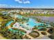 Breathtaking aerial view showcasing a vibrant community pool and lake at 3013 Latitude Ln, Kissimmee, FL 34747