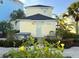 Cozy backyard featuring lush landscaping, a spa, and outdoor seating, ideal for relaxation and entertaining at 3013 Latitude Ln, Kissimmee, FL 34747