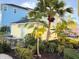 Backyard with a patio table, chairs, and tropical landscaping for outdoor relaxation and privacy at 3013 Latitude Ln, Kissimmee, FL 34747