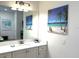Bathroom featuring a large mirror over a white vanity and tropical-themed decor at 3013 Latitude Ln, Kissimmee, FL 34747