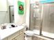 Bathroom with a glass-enclosed shower and a single sink vanity with decor at 3013 Latitude Ln, Kissimmee, FL 34747