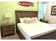 Bedroom with a wooden bed frame, two wooden nightstands, and coastal-themed decor at 3013 Latitude Ln, Kissimmee, FL 34747