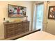 Bedroom with a wooden dresser, a large television, and tropical-themed decor at 3013 Latitude Ln, Kissimmee, FL 34747