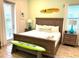 Bedroom with a wooden bed frame, two wooden nightstands, and tropical-themed decor at 3013 Latitude Ln, Kissimmee, FL 34747