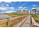 Scenic view of the community featuring colorful townhomes and a walking bridge at 3013 Latitude Ln, Kissimmee, FL 34747