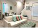 Cozy living room with comfortable seating, a dining table, and staircase access at 3013 Latitude Ln, Kissimmee, FL 34747
