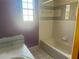 Bathroom features a tub and shower combination and a window for natural light at 3123 Tamarind Dr, Edgewater, FL 32141