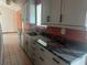 Kitchen featuring sleek granite countertops, grey cabinets and a stainless sink at 3123 Tamarind Dr, Edgewater, FL 32141