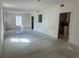 Bright living room featuring large windows, an open floor plan, and easy access to the kitchen at 3123 Tamarind Dr, Edgewater, FL 32141
