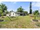 Large backyard with a hammock, playhouse, mature trees, and screened-in porch at 3520 Balsam Dr, Winter Park, FL 32792