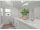 Bright bathroom with double vanity, white cabinets, large mirror, and a shower at 3520 Balsam Dr, Winter Park, FL 32792