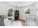 Bright bedroom with a cozy chair and baby crib, perfect for a Bedroom or guest room at 3520 Balsam Dr, Winter Park, FL 32792