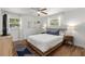 Serene bedroom featuring wood floors and a comfortable bed, illuminated by natural light at 3520 Balsam Dr, Winter Park, FL 32792