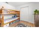 Bedroom featuring hardwood floors, a wooden bunk bed, a closet and a black and white rug at 3520 Balsam Dr, Winter Park, FL 32792