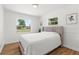 Bright bedroom offers natural light, wood-look floors, and a comfortable upholstered headboard at 3520 Balsam Dr, Winter Park, FL 32792