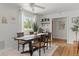 Bright dining room featuring wood floors, modern table, and an open coffee and beverage bar area at 3520 Balsam Dr, Winter Park, FL 32792