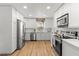 Modern kitchen featuring stainless steel appliances, ample cabinet space and hardwood floors at 3520 Balsam Dr, Winter Park, FL 32792