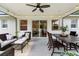Covered patio featuring ceiling fan, outdoor furniture, dining table and view of the backyard through sliding glass doors at 3520 Balsam Dr, Winter Park, FL 32792