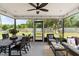 Screened patio featuring ceiling fan, outdoor furniture, dining table and view of the spacious, grassy backyard at 3520 Balsam Dr, Winter Park, FL 32792