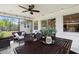 Screened patio with ceiling fan, outdoor furniture, dining table and view of the large, grassy backyard at 3520 Balsam Dr, Winter Park, FL 32792