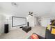 Large bonus room with projector screen, ceiling fan, and a comfortable seating area perfect for movie nights at 3697 Rolling Hills Ln, Apopka, FL 32712