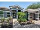 The house's front entrance boasts detailed trim work, a brick walkway, and well-kept landscaping at 3697 Rolling Hills Ln, Apopka, FL 32712