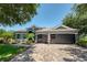 The house has a three-car garage, a brick driveway, and an American flag for added character at 3697 Rolling Hills Ln, Apopka, FL 32712