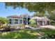 Charming single-Gathering home with a well-manicured lawn, brick walkway, and a beautiful blue exterior at 3697 Rolling Hills Ln, Apopka, FL 32712