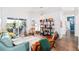 A sun-filled living room with hardwood floors, sliding door access to patio, and stylish decor at 3697 Rolling Hills Ln, Apopka, FL 32712