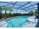Inviting screened-in pool area featuring a crystal-clear pool, lush landscaping, and ample space for lounging at 3697 Rolling Hills Ln, Apopka, FL 32712