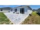 Backyard with paved patio, seating area, and sliding glass doors for seamless indoor-outdoor living at 3838 Whitetail Ct, St Cloud, FL 34772