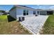 Backyard with paved patio, seating area, and an AC unit, ready for outdoor enjoyment at 3838 Whitetail Ct, St Cloud, FL 34772