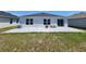 Backyard featuring a paved patio with seating and a fire pit, blending outdoor enjoyment at 3838 Whitetail Ct, St Cloud, FL 34772