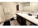 Bathroom featuring a sleek vanity with a marble countertop, modern fixtures, and dark cabinets at 3838 Whitetail Ct, St Cloud, FL 34772