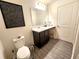 Bathroom featuring a sleek vanity with a marble countertop, modern fixtures, and dark cabinets at 3838 Whitetail Ct, St Cloud, FL 34772