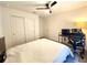 Bedroom with ceiling fan, closet, wood-style laminate flooring and a large bed frame at 3838 Whitetail Ct, St Cloud, FL 34772