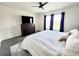 Primary bedroom includes a ceiling fan, modern flooring, a large window and tasteful furnishings at 3838 Whitetail Ct, St Cloud, FL 34772
