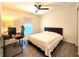 Bedroom with ceiling fan, wood-style laminate flooring and a large bed frame at 3838 Whitetail Ct, St Cloud, FL 34772