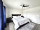 A well lit primary bedroom with dark furnishings, a ceiling fan and modern flooring at 3838 Whitetail Ct, St Cloud, FL 34772