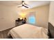Bedroom with sleek ceiling fan, desk area, and wood-style laminate flooring at 3838 Whitetail Ct, St Cloud, FL 34772