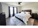 A Primary bedroom with ceiling fan, a king-sized bed, side tables and a modern area rug at 3838 Whitetail Ct, St Cloud, FL 34772
