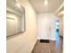 Bright entryway featuring wood-look flooring, a large mirror and a white front door at 3838 Whitetail Ct, St Cloud, FL 34772