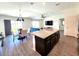 Spacious kitchen featuring an island with granite counters with open floor plan to living and dining areas at 3838 Whitetail Ct, St Cloud, FL 34772